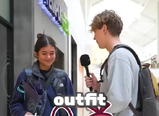 John Rusanov doing a street interview with a girl relating to outfits.