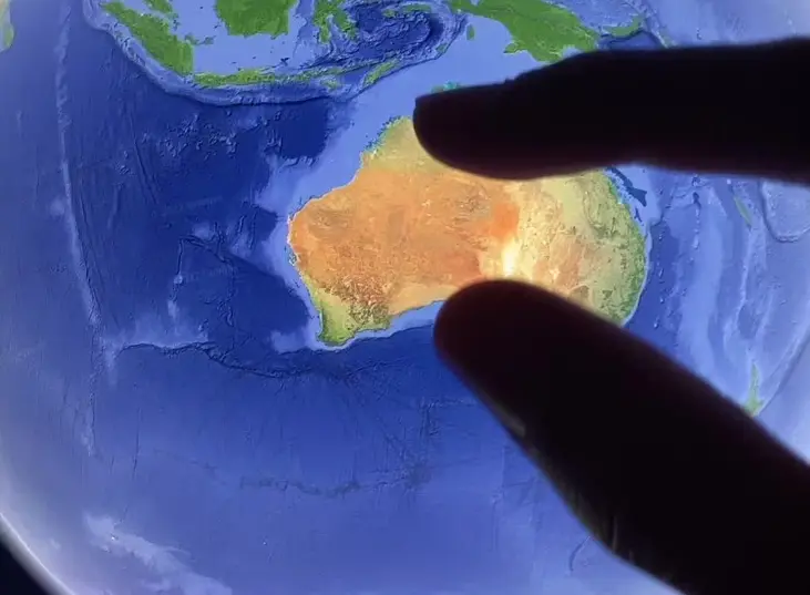 Someone pinch zooming in on Google Maps over Australia