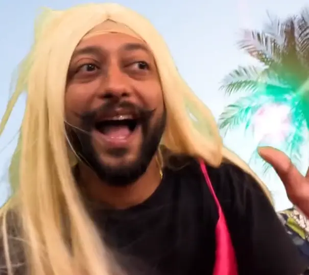 Indian restaurant chef wearing a Barbie outfit and singing for a TikTok video